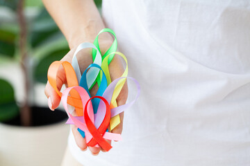 Female doctor holds colored ribbons symbolize awareness of various diseases