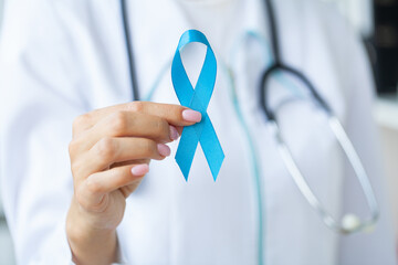 Woman with blue ribbon, prostate cancer awareness