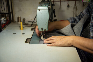 Tailor sewing clothes for customers