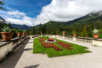 Fototapeta na wymiar Terraced formal garden with lawn and flowerbeds