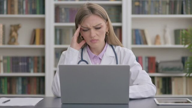 Lady Doctor having Headache while Working on Laptop