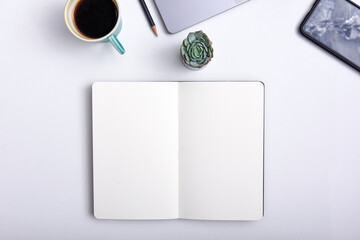 Trendy work space with open note book on desk