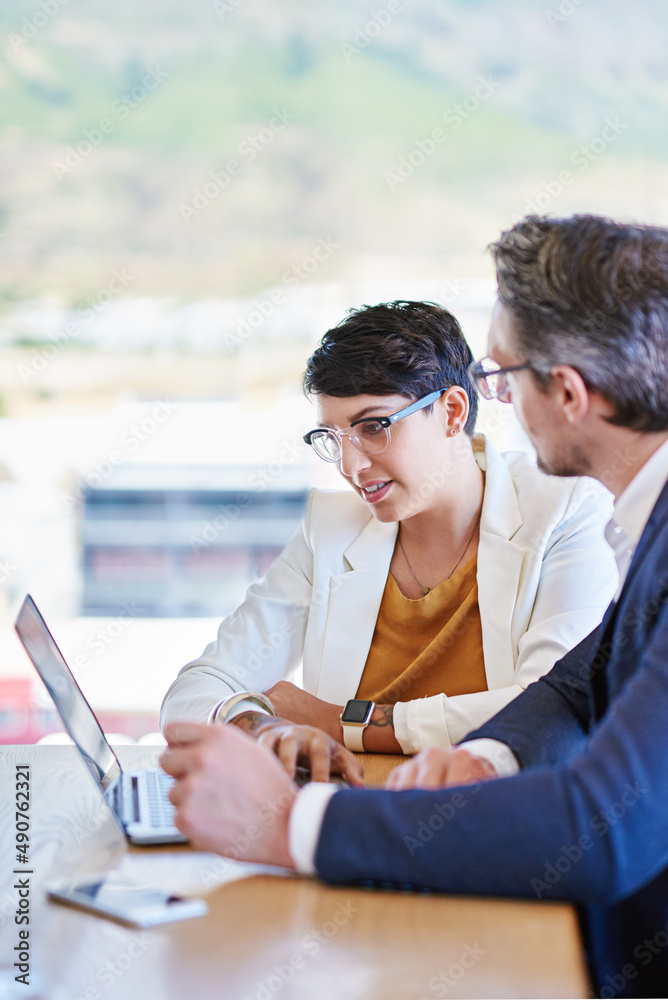 Poster sharing ideas for the betterment of business. shot of two colleagues working on a laptop at a desk i