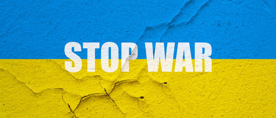 Ukranian flag painted on a concrete wall with Stop war word symbol