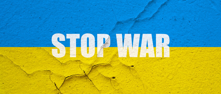 Ukranian flag painted on a concrete wall with Stop war word symbol