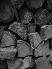 stacked firewood, black and white