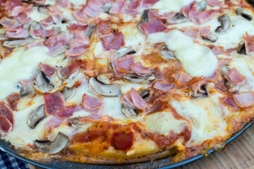 Freshly made ham and mozzarella pizza