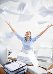 I wish I could be free of all this paperwork. Conceptual shot of a young businesswoman throwing...