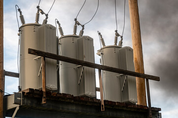 High voltage elevated transformer bank with smoke being emitted before failure.