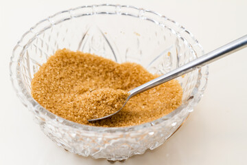 Glass sugar bowl with brown sugar