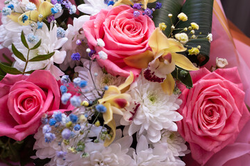 Beautiful festive bouquet of flowers. Bouquet with pink lush roses for the holiday and greeting card. High quality photo