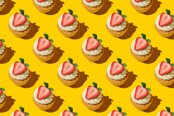 Pattern made of home cookies with strawberries and cream. cupcake with big strawberry on top. Repeating  homemade cookies with strawberries and cream pattern. Flat lay style.