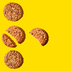 Oatmeal cookies with seeds on a yellow background.