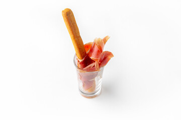 Serving appetizers in a tasting glass: salmon, prawn, cheese, ham, caviar and olives. Beautifully decorated catering banquet menu. Food snacks and appetizers for buffet. Isolated on white backgroun