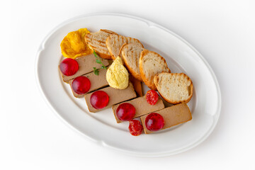 Chicken turkey pate with berry jelly and toast on a white plate. Banquet festive dishes. Gourmet restaurant menu. White background.
