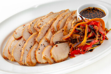 Chicken pastrami with stewed vegetables and sauce on a white plate. Banquet festive dishes. Gourmet restaurant menu. White background.