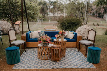 lounge with blue upholstery and wood finish with rug outdoors outdoor wedding decor space for rest