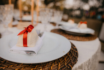 wedding plate on table set with wedding gifts for wedding guests