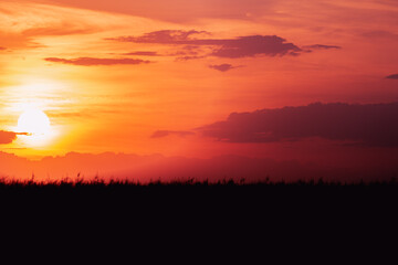 Sunset and red sky with clouds.