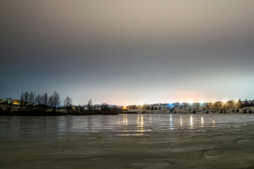 forest in the night . Night landscape. Nightsky and clouds . Stars in the sky . Lights of the city .