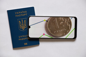 The Russian ruble and a histogram with statistics on the phone on a white background and a foreign...
