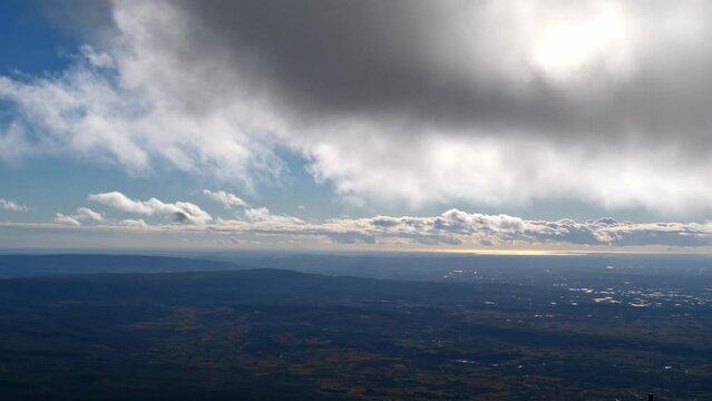 View from the top of Mont Ventoux in southern direction on windy day in autumn season with clouds passing by in Provence region, southern France.