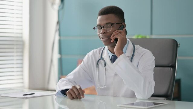 Young African Doctor Talking on Phone in Office 