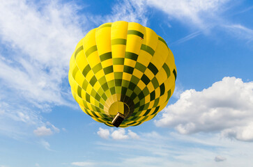 Colorful hot air balloon flying over blue sky