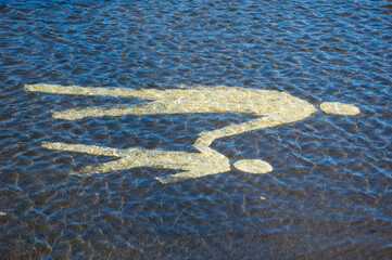 Closeup of high water flooding on sidewalk with horizontal sign.