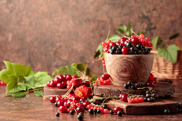 Cherries, red and black currants on the kitchen table.