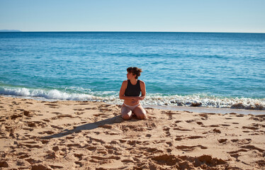 Fototapeta na wymiar A closeup of a young woman sitting on the beach