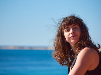 Naklejka premium A portrait of a young Caucasian girl on the beach in Spain