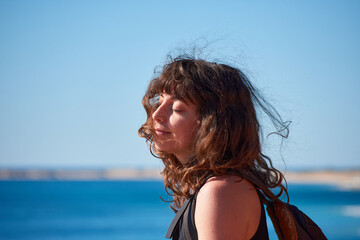 Naklejka premium A portrait of a young Caucasian girl on the beach in Spain