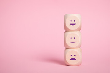 Wooden blocks with smilies faces symbols on Pinkbackground, evaluation, Increase rating, Customer...
