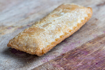 wheat pastries with red cherry strawberry filling on a board