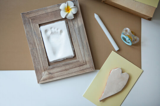 Baby Footprint On Clay Mold In Frame. To Remember Cute Frame Images Cheerful Childhood Celebration