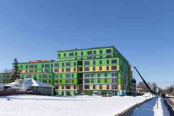 Winter construction of condos around houses