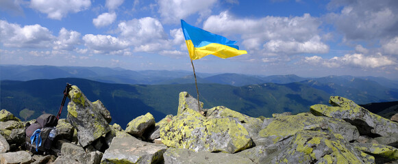 Panoramic view of Gorgany Mountains with Ukrainian flag. 