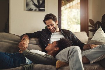 He satisfies my soul. Shot of a happy young couple relaxing on a sofa and spending time together at...