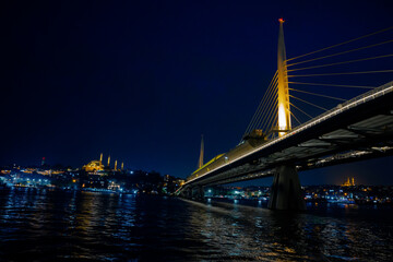 Istanbul night. Halic Metro Bridge and Suleymaniye Mosque with Golden Horn