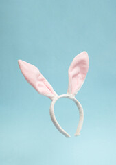 Bunny rabbit ears headband on pastel blue background. Happy Easter minimal concept.