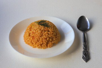 Traditional turkish bulgur pilaf with tomato sause in plate (Turkish name; meyhane pilavi)