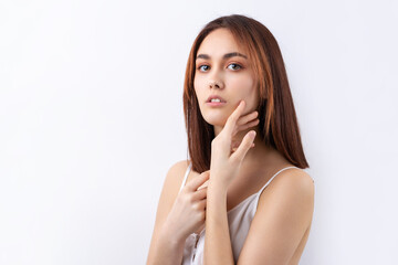 Fototapeta premium Beautiful smiling woman with clean skin, natural make-up and white teeth on a gray background
