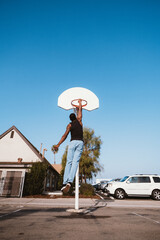 Black Man Slam Dunk on Outdoor Basketball court