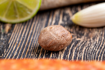 a whole nutmeg on a wooden board