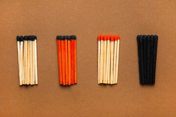Different new matchsticks on brown background