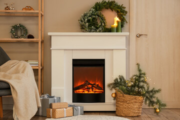 Interior of modern room with fireplace and Christmas decorations