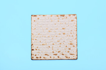 Jewish flatbread matza for Passover on blue background