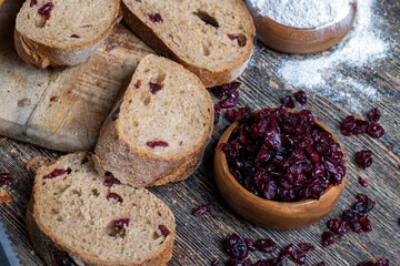 Fototapeta na wymiar fresh cut bread made of flour and dried cranberries