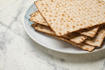 Plate with Jewish flatbread for Passover on white background